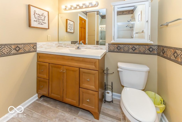 2457 N Centerline Rd, Franklin, IN 46131 - bathroom featuring toilet, vanity, decorative backsplash, and wood finished floors
