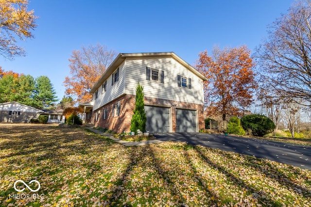 2457 N Centerline Rd, Franklin, IN 46131 - view of side of property with brick siding, driveway, and a garage