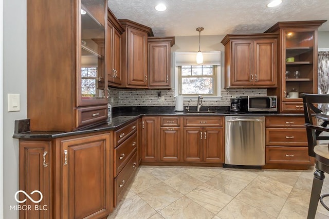 2457 N Centerline Rd, Franklin, IN 46131 - kitchen with appliances with stainless steel finishes, a sink, tasteful backsplash, hanging light fixtures, and a textured ceiling