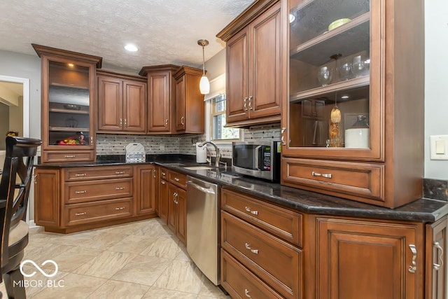 2457 N Centerline Rd, Franklin, IN 46131 - kitchen with appliances with stainless steel finishes, a sink, tasteful backsplash, pendant lighting, and brown cabinetry