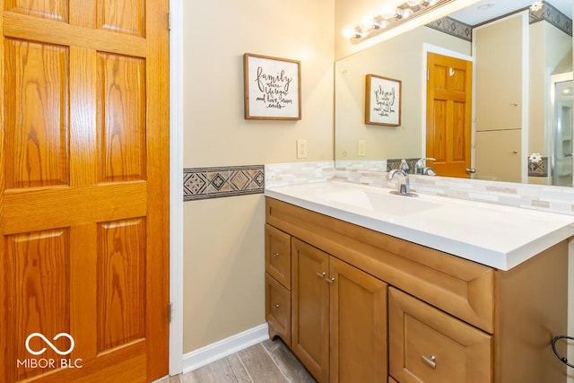 2457 N Centerline Rd, Franklin, IN 46131 - bathroom with vanity, tasteful backsplash, and wood finished floors