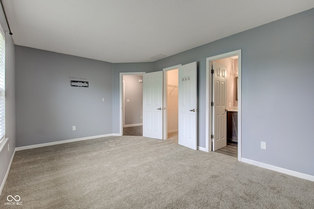 7918 Bitternut Dr, Indianapolis, IN 46236 - unfurnished bedroom with carpet, a walk in closet, baseboards, and a closet