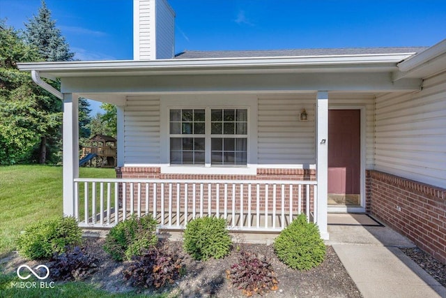 11830 Sand Creek Blvd, Fishers, IN 46037 - property entrance featuring covered porch, brick siding, a yard, and a chimney