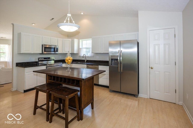 11830 Sand Creek Blvd, Fishers, IN 46037 - kitchen featuring stainless steel appliances, white cabinetry, plenty of natural light, light wood finished floors, and high vaulted ceiling