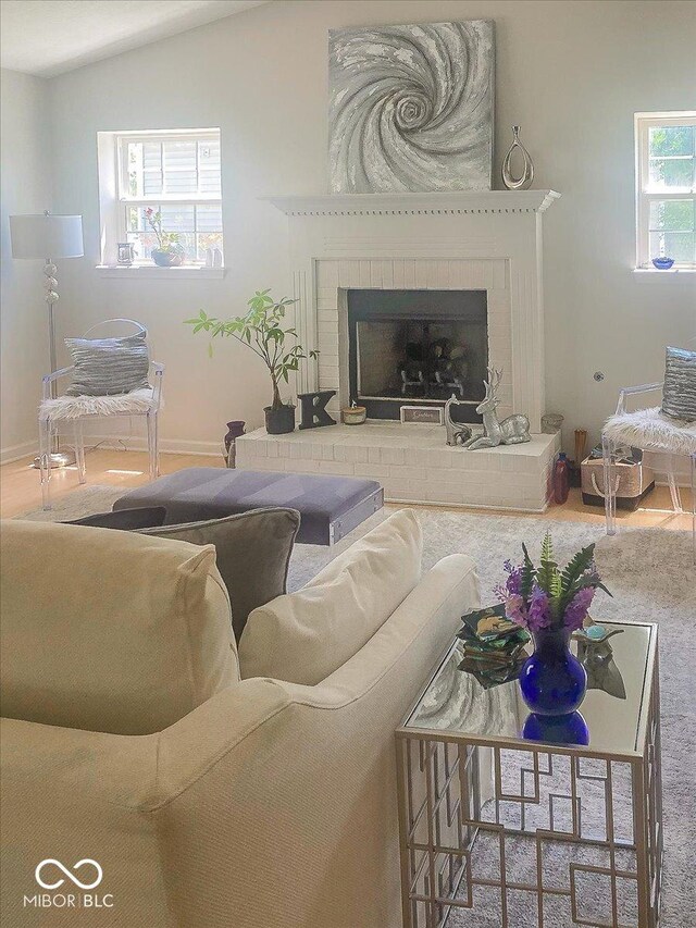 11830 Sand Creek Blvd, Fishers, IN 46037 - carpeted living area featuring a brick fireplace and vaulted ceiling
