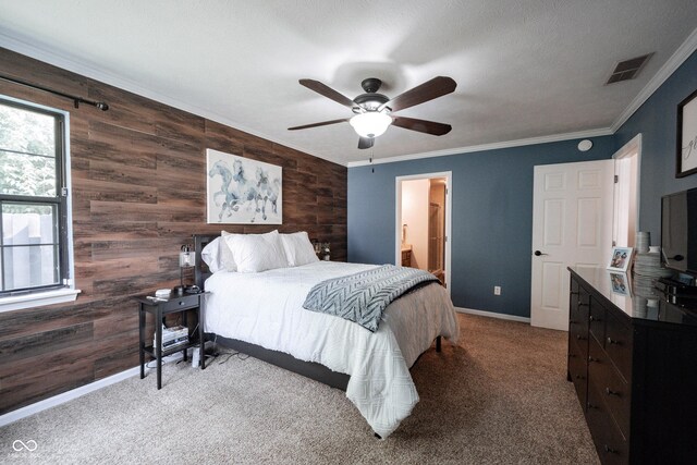 7686 Micawber Ct, Indianapolis, IN 46256 - carpeted bedroom featuring wood walls, an accent wall, crown molding, a ceiling fan, and ensuite bathroom