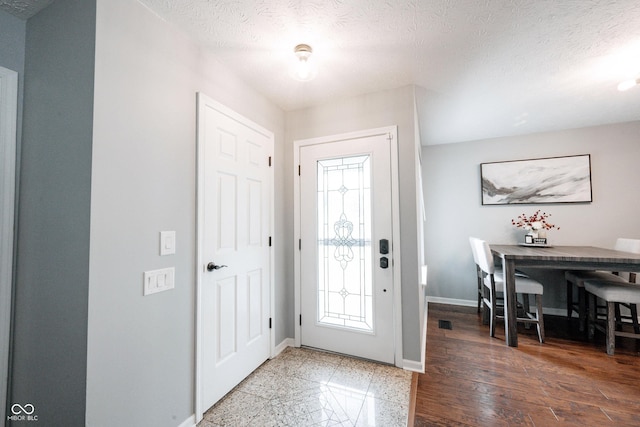 7686 Micawber Ct, Indianapolis, IN 46256 - entryway featuring baseboards and a textured ceiling
