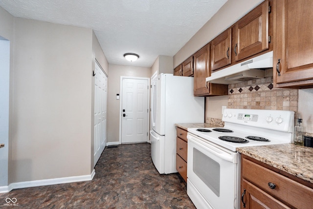 7686 Micawber Ct, Indianapolis, IN 46256 - kitchen with white appliances, under cabinet range hood, brown cabinets, decorative backsplash, and a textured ceiling