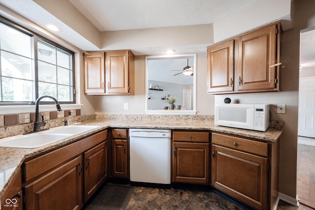 7686 Micawber Ct, Indianapolis, IN 46256 - kitchen with white appliances, light countertops, a ceiling fan, and dark stone finish flooring