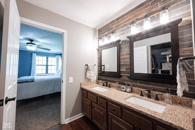 7686 Micawber Ct, Indianapolis, IN 46256 - full bathroom with ensuite bath, double vanity, wood finished floors, and a ceiling fan
