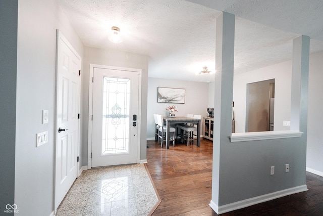 7686 Micawber Ct, Indianapolis, IN 46256 - foyer with a textured ceiling and wood finished floors