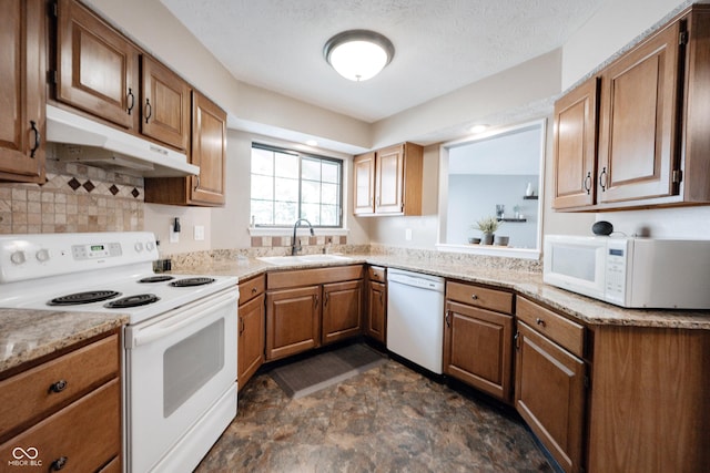 7686 Micawber Ct, Indianapolis, IN 46256 - kitchen featuring white appliances, under cabinet range hood, brown cabinetry, backsplash, and stone finish flooring