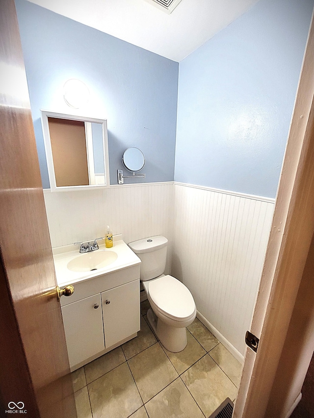 22 Brooklyn Ct, Mooresville, IN 46158 - half bathroom with vanity, wainscoting, toilet, and tile patterned flooring