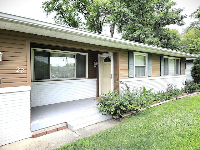 22 Brooklyn Ct, Mooresville, IN 46158 - view of front of house featuring a porch, a front lawn, and brick siding