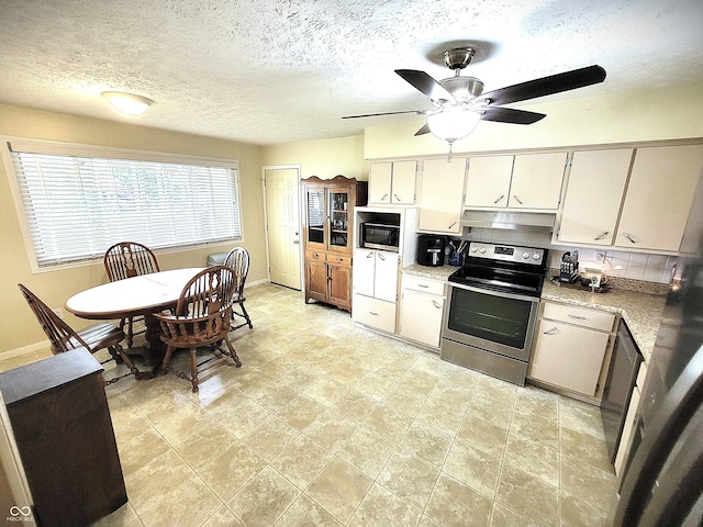 22 Brooklyn Ct, Mooresville, IN 46158 - kitchen with stainless steel range with electric stovetop, under cabinet range hood, ceiling fan, light countertops, and baseboards