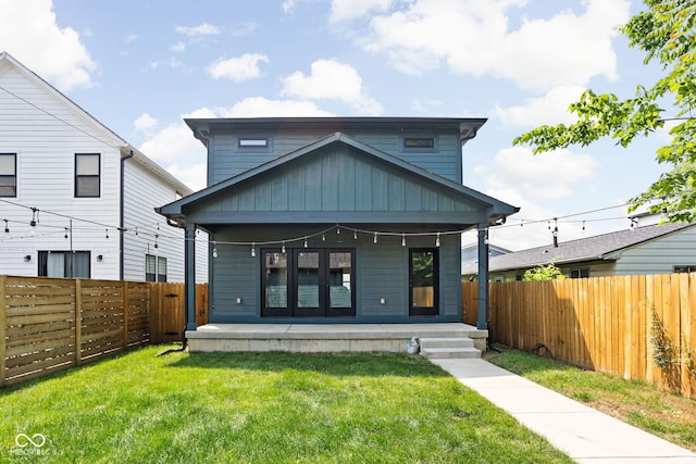 1717 Carrollton Ave, Indianapolis, IN 46202 - view of front facade featuring board and batten siding, a porch, and a fenced backyard