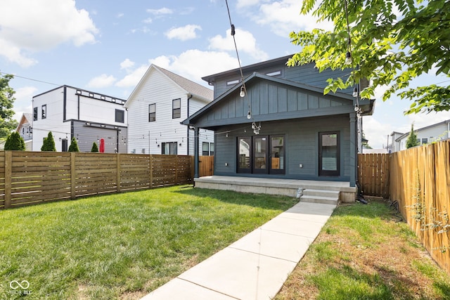 1717 Carrollton Ave, Indianapolis, IN 46202 - rear view of house featuring board and batten siding and a fenced backyard