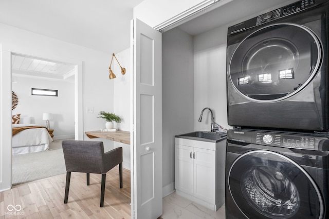 1717 Carrollton Ave, Indianapolis, IN 46202 - laundry area featuring estacked washer and dryer and cabinet space