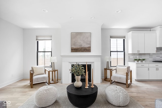 1717 Carrollton Ave, Indianapolis, IN 46202 - living area with healthy amount of natural light, light wood-type flooring, a glass covered fireplace, and recessed lighting