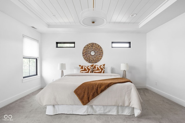 1717 Carrollton Ave, Indianapolis, IN 46202 - bedroom with a tray ceiling, wooden ceiling, carpet flooring, and multiple windows