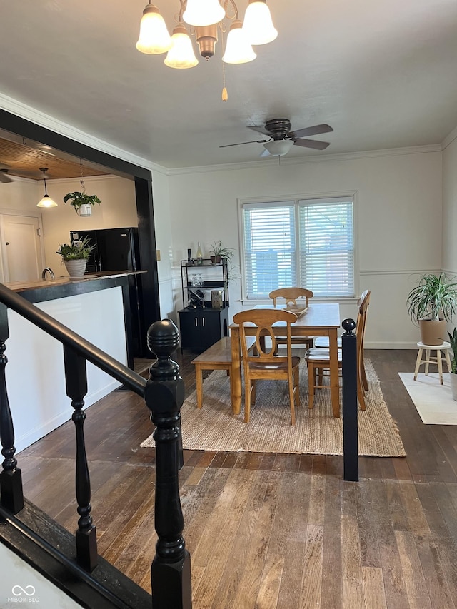26 Oakwood Ave, North Vernon, IN 47265 - dining room featuring a ceiling fan, wood finished floors, crown molding, baseboards, and a chandelier