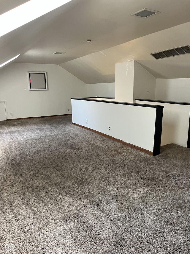 26 Oakwood Ave, North Vernon, IN 47265 - additional living space with vaulted ceiling, carpet floors, and baseboards