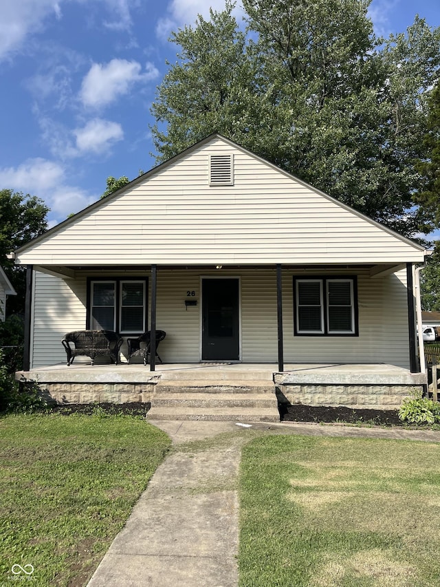 26 Oakwood Ave, North Vernon, IN 47265 - bungalow-style home with a porch and a front yard
