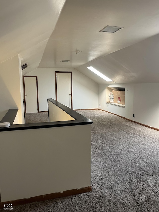 26 Oakwood Ave, North Vernon, IN 47265 - additional living space with carpet flooring, lofted ceiling, and baseboards