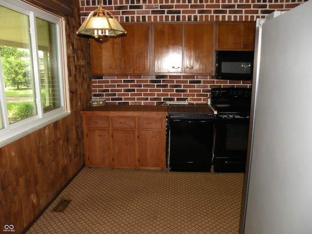 1796 N 400 W, Crawfordsville, IN 47933 - kitchen with black appliances, wood walls, dark countertops, brown cabinetry, and tasteful backsplash