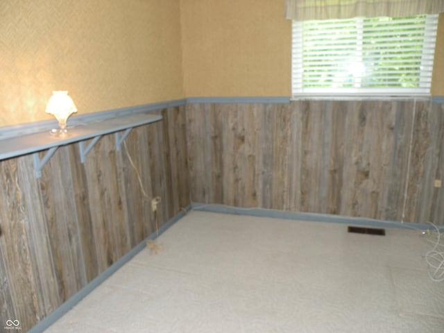 1796 N 400 W, Crawfordsville, IN 47933 - spare room featuring a wainscoted wall, wooden walls, and carpet