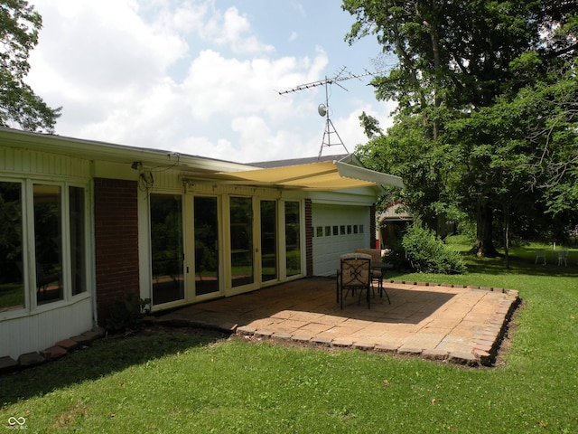 1796 N 400 W, Crawfordsville, IN 47933 - back of house featuring a yard, a garage, a patio area, and brick siding