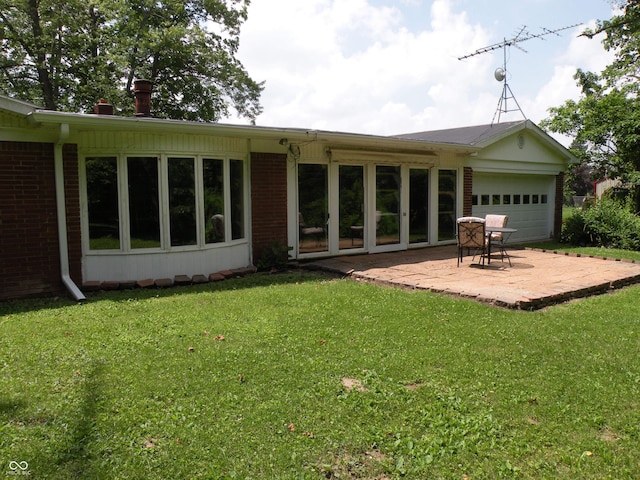 1796 N 400 W, Crawfordsville, IN 47933 - back of property with a lawn, a patio, a garage, and brick siding