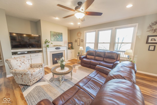 226 S Cave Creek Dr S, Bloomington, IN 47403 - living area with ceiling fan, wood finished floors, a fireplace, baseboards, and recessed lighting