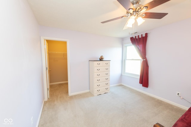 226 S Cave Creek Dr S, Bloomington, IN 47403 - bedroom with a walk in closet, light carpet, baseboards, and a ceiling fan