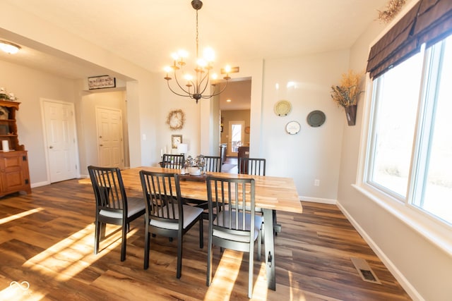 226 S Cave Creek Dr S, Bloomington, IN 47403 - dining space featuring a chandelier, dark wood-style flooring, and baseboards