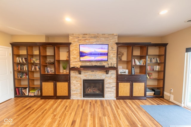226 S Cave Creek Dr S, Bloomington, IN 47403 - living room with light wood-type flooring, a stone fireplace, baseboards, and recessed lighting