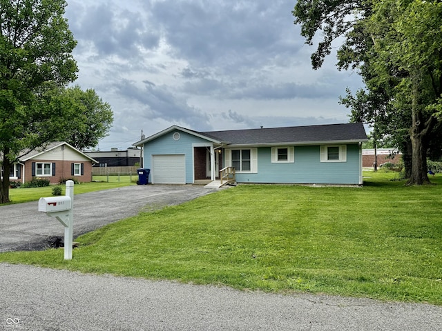 1002 Meadow Ln, Greencastle, IN 46135 - single story home featuring an attached garage, asphalt driveway, and a front yard