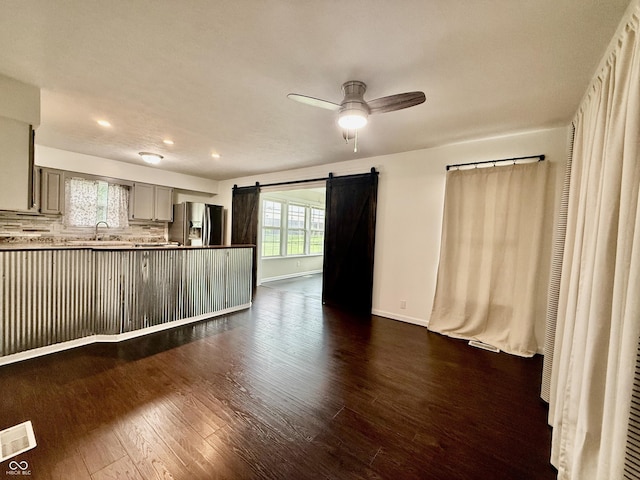 1002 Meadow Ln, Greencastle, IN 46135 - unfurnished living room featuring ceiling fan, dark wood-style floors, recessed lighting, baseboards, and a barn door