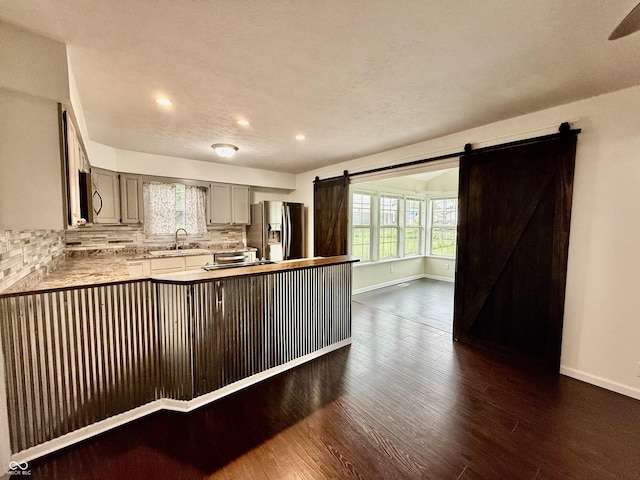 1002 Meadow Ln, Greencastle, IN 46135 - kitchen with a barn door, appliances with stainless steel finishes, dark wood-style flooring, baseboards, and recessed lighting