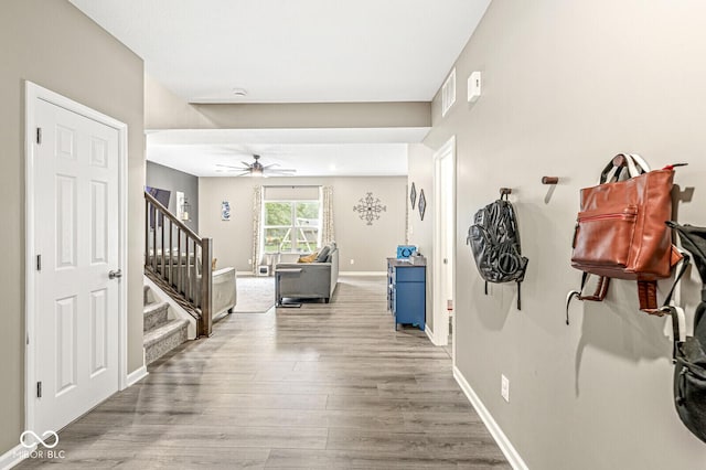 126 Winding Brook Way, Pendleton, IN 46064 - hallway featuring wood finished floors, stairway, and baseboards