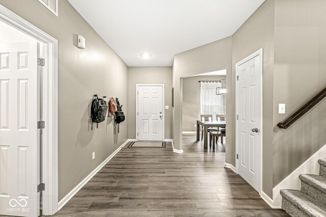126 Winding Brook Way, Pendleton, IN 46064 - entryway featuring stairway, baseboards, and dark wood-style floors