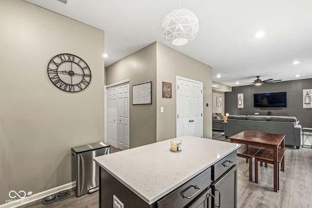 126 Winding Brook Way, Pendleton, IN 46064 - kitchen with baseboards, light wood finished floors, a ceiling fan, recessed lighting, and light stone counters