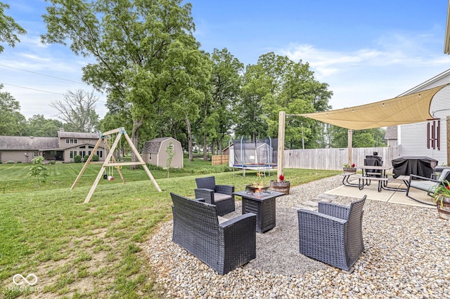 126 Winding Brook Way, Pendleton, IN 46064 - view of yard featuring a trampoline, a patio, a playground, and a fire pit