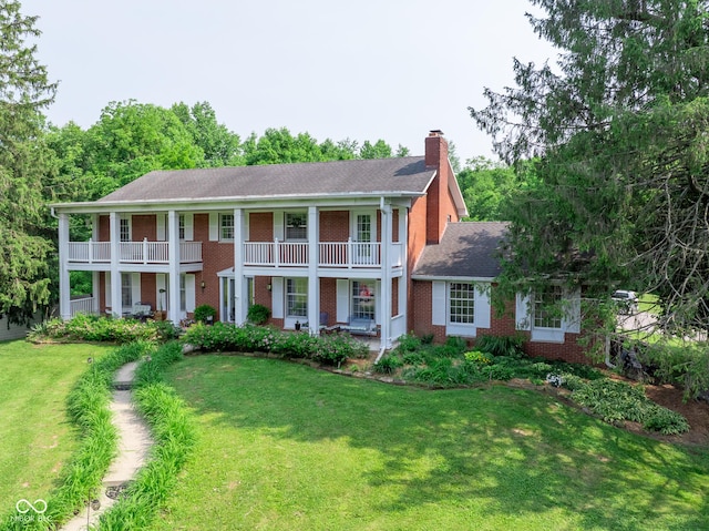 9550 E State Road 46, Bloomington, IN 47401 - greek revival inspired property with brick siding, a chimney, covered porch, a balcony, and a front lawn