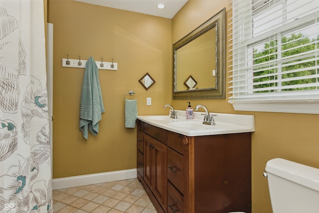 9550 E State Road 46, Bloomington, IN 47401 - bathroom with double vanity, baseboards, toilet, and tile patterned floors