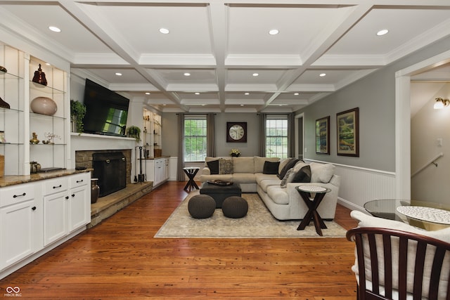9550 E State Road 46, Bloomington, IN 47401 - living area with a stone fireplace, dark wood-type flooring, recessed lighting, beam ceiling, and a wainscoted wall