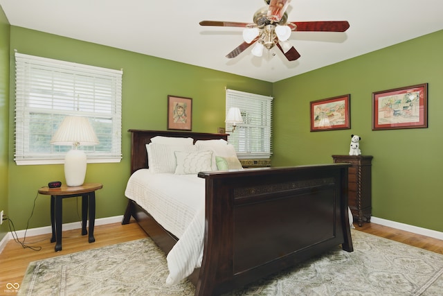 9550 E State Road 46, Bloomington, IN 47401 - bedroom featuring wood finished floors, baseboards, and a ceiling fan