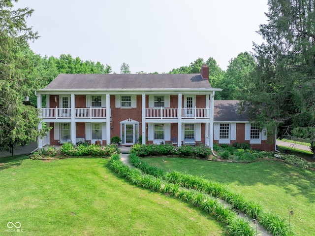 9550 E State Road 46, Bloomington, IN 47401 - greek revival house with brick siding, a chimney, a balcony, and a front lawn