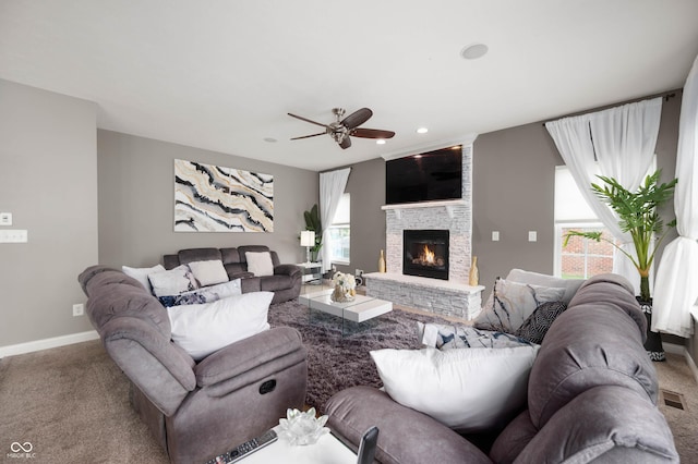 1143 Hampton Dr, Greenwood, IN 46143 - living room featuring carpet, a ceiling fan, a stone fireplace, plenty of natural light, and recessed lighting