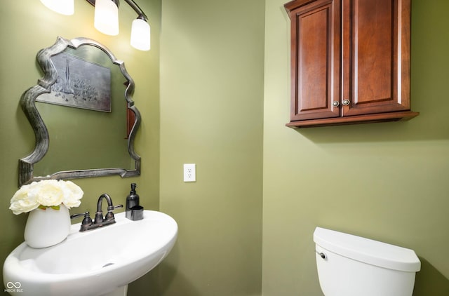 1143 Hampton Dr, Greenwood, IN 46143 - half bathroom featuring a sink and toilet